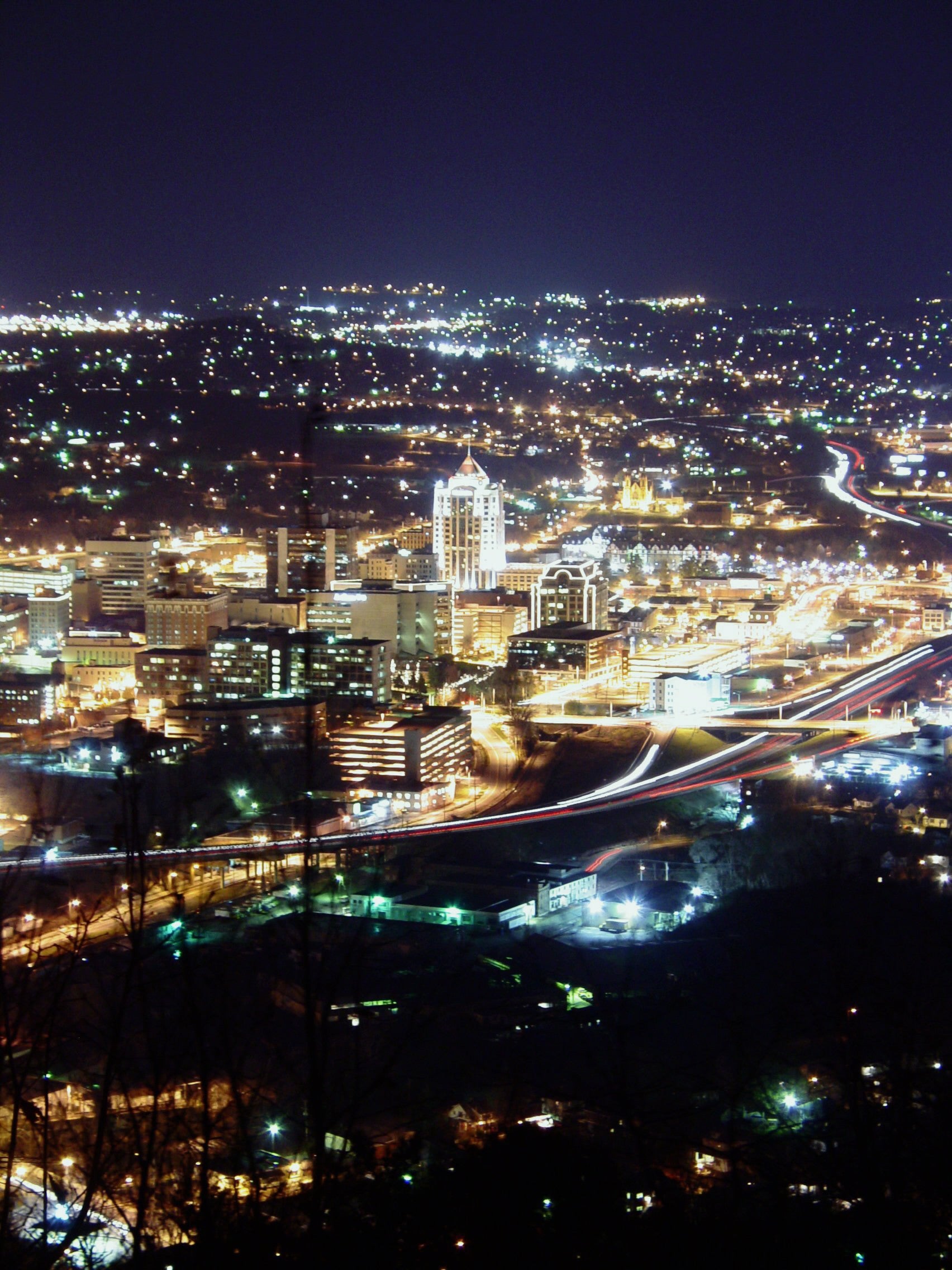 Cityscape at night with illuminated buildings and roads